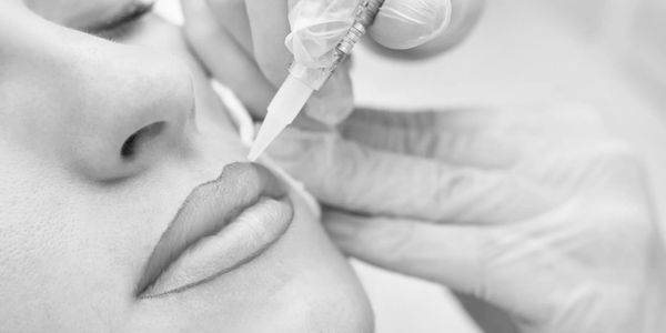 Lip tattooing procedure in progress.