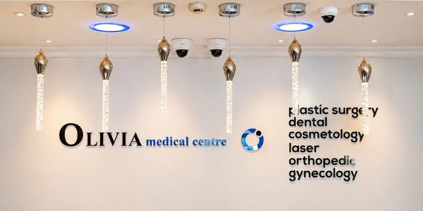 Reception wall of Olivia Medical Centre with services listed.