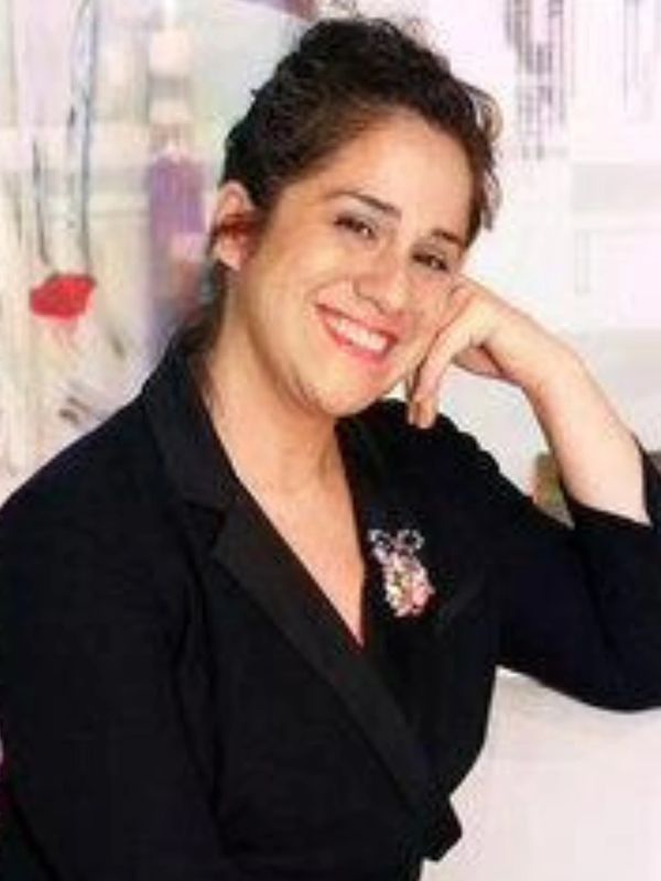 Smiling woman resting her head on her hand.