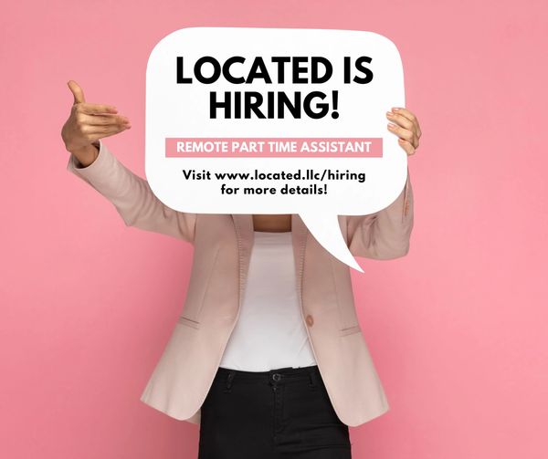 Person holding sign announcing hiring for remote part-time assistant position.