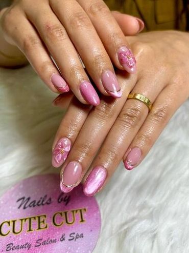 Elegant almond-shaped pink gel manicure featuring 3D floral accent nails, shimmering magnetic cat-ey