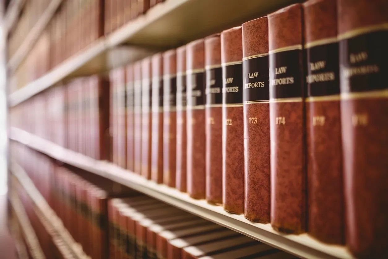 Row of brown law report books neatly arranged on a shelf.