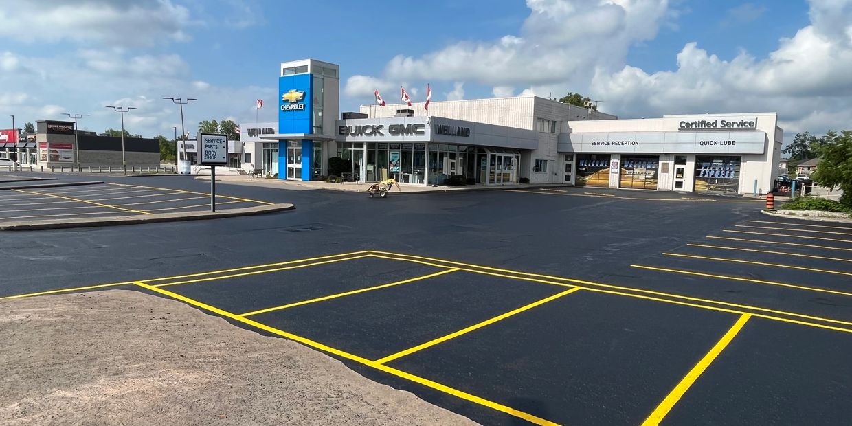 Newly painted parking lot outside a Buick GMC and Chevrolet dealership.