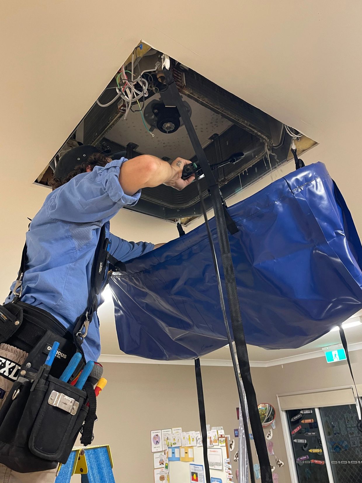 A cassette air-conditioner being professionally cleaned