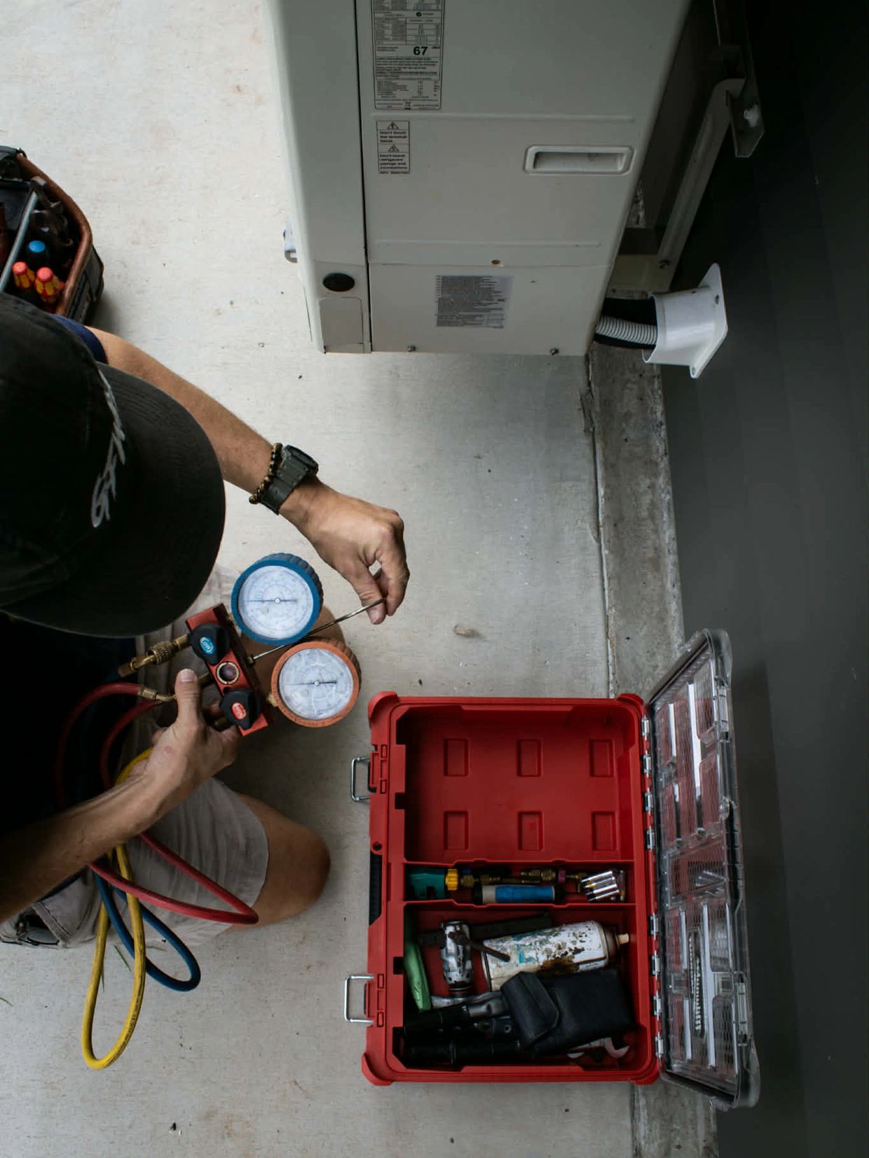 A photo of a tradesman with his air-conditioning tools