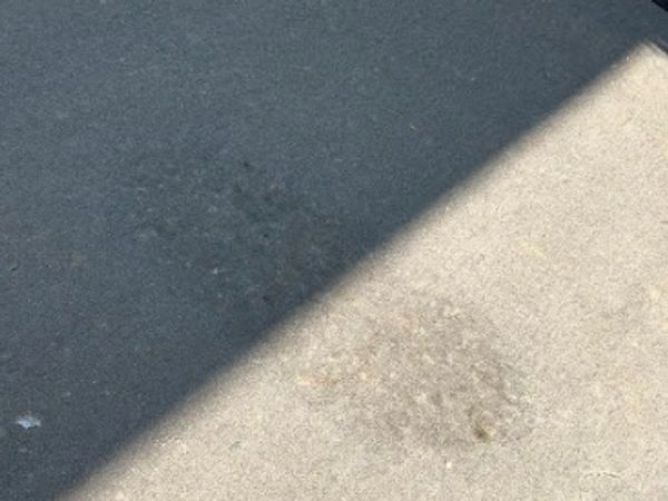 Concrete driveway after oil stain removal in Springfield MO with professional pressure washing
