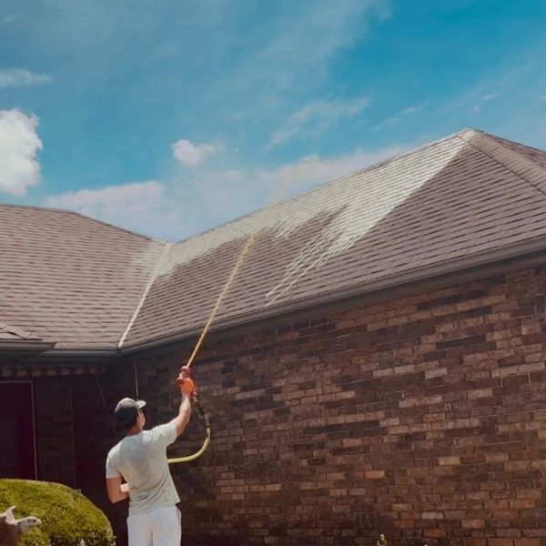 Roof soft washing a home exterior to remove dirt, algae, and mildew in Springfield MO