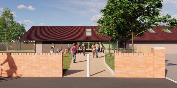 People walking into a community building on a sunny day.