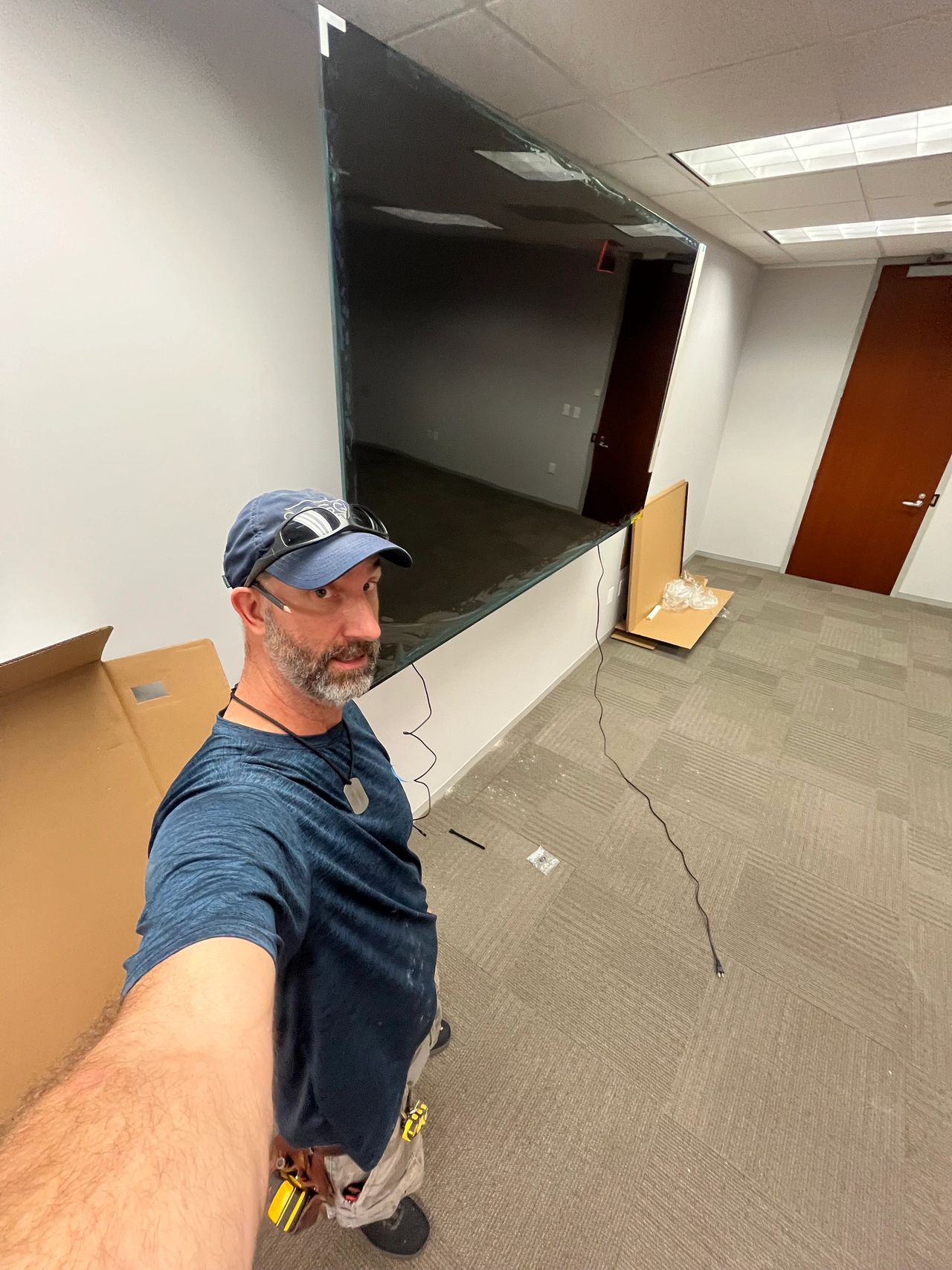 Adam Taylor the Handyman hanging a 100 inch TV