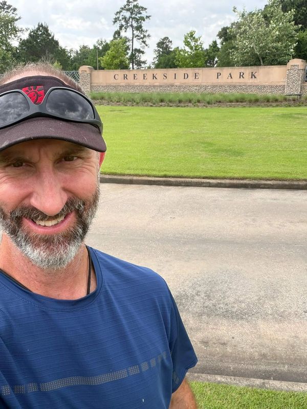 Adam Taylor the Handyman standing in front of the Creekside Park entrance, The Woodlands, TX
