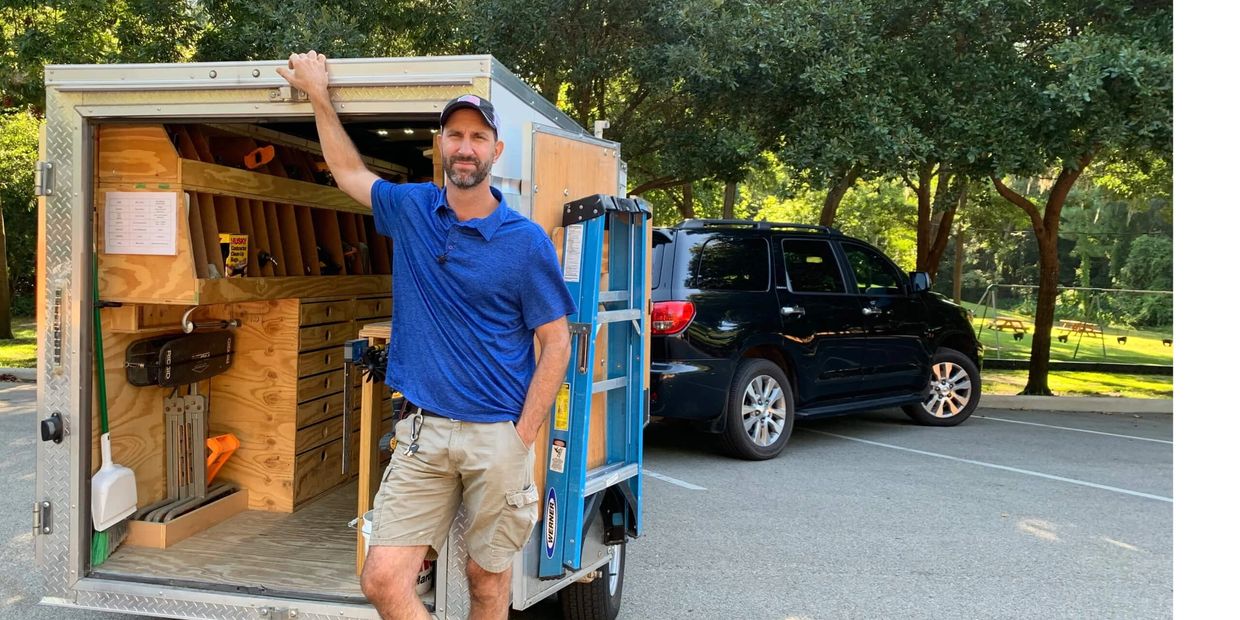 Adam Taylor the Handyman standing next to his Ultimate Handyman Trailer