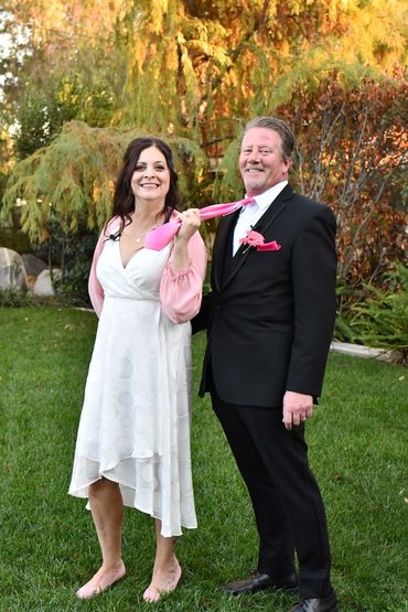 Bride pulling Groom by tie.