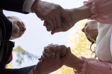 Married couple holding hands.