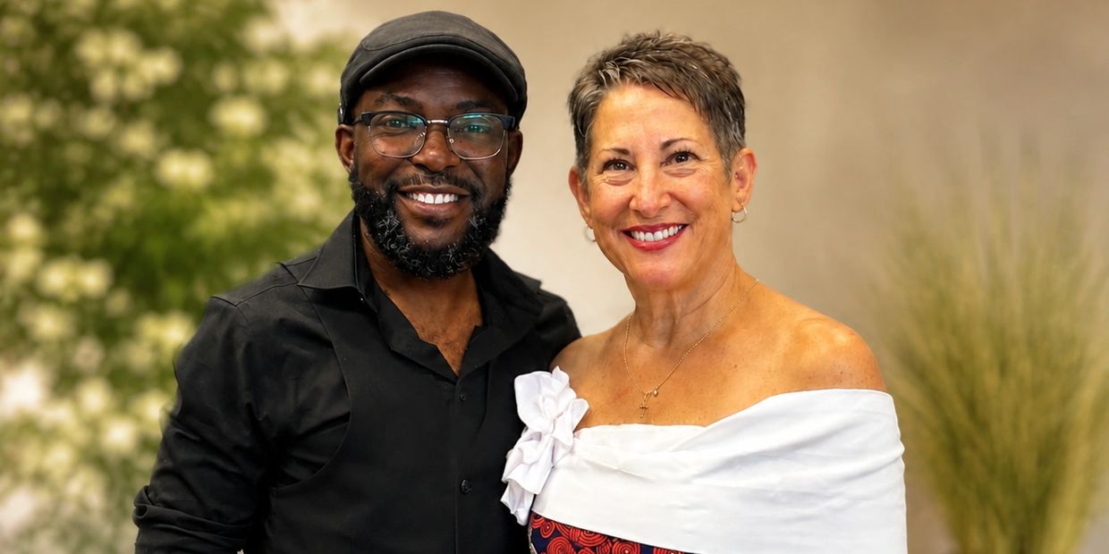 Smiling man and woman posing together indoors.