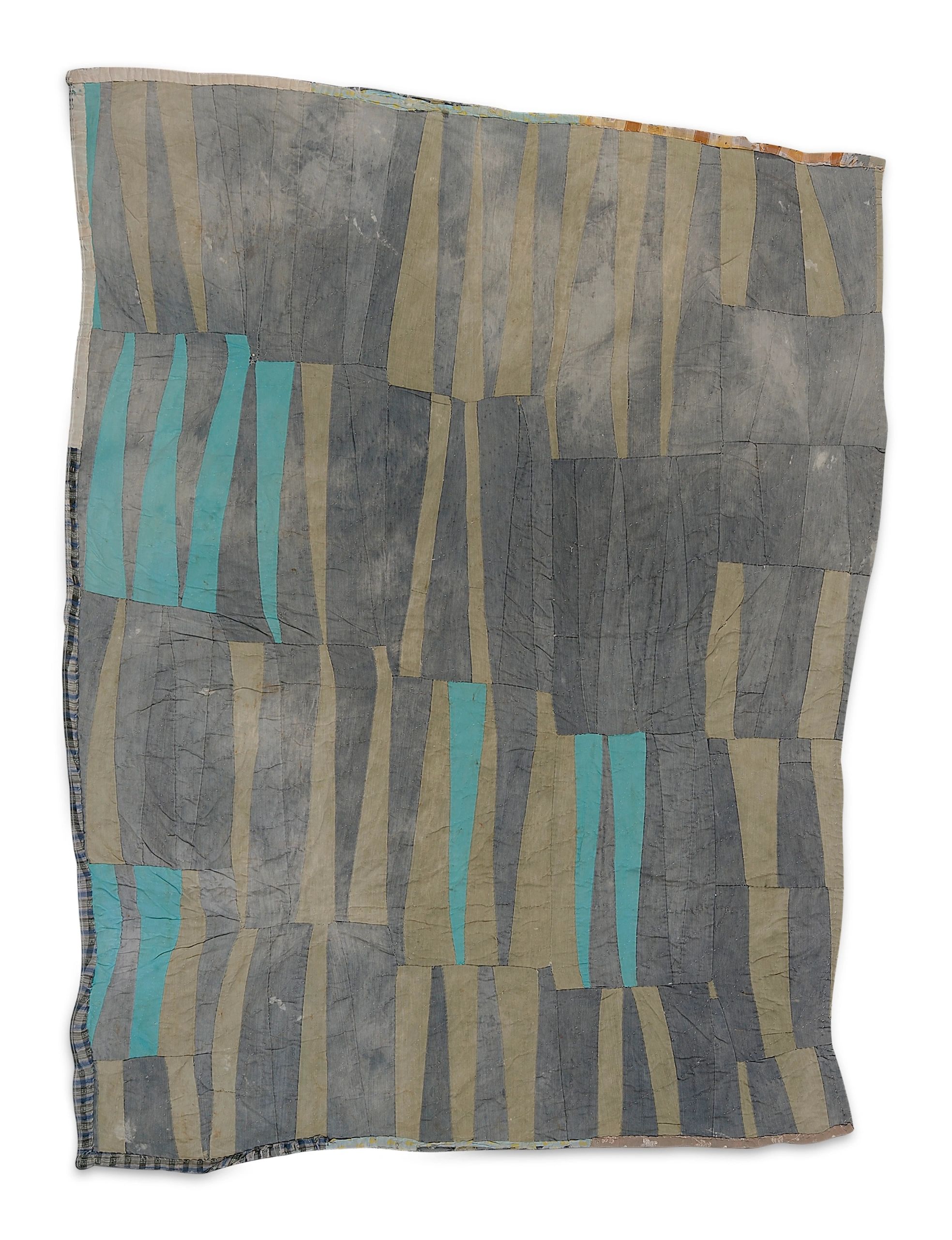 Abstract patchwork textile with muted blue and gray tones.