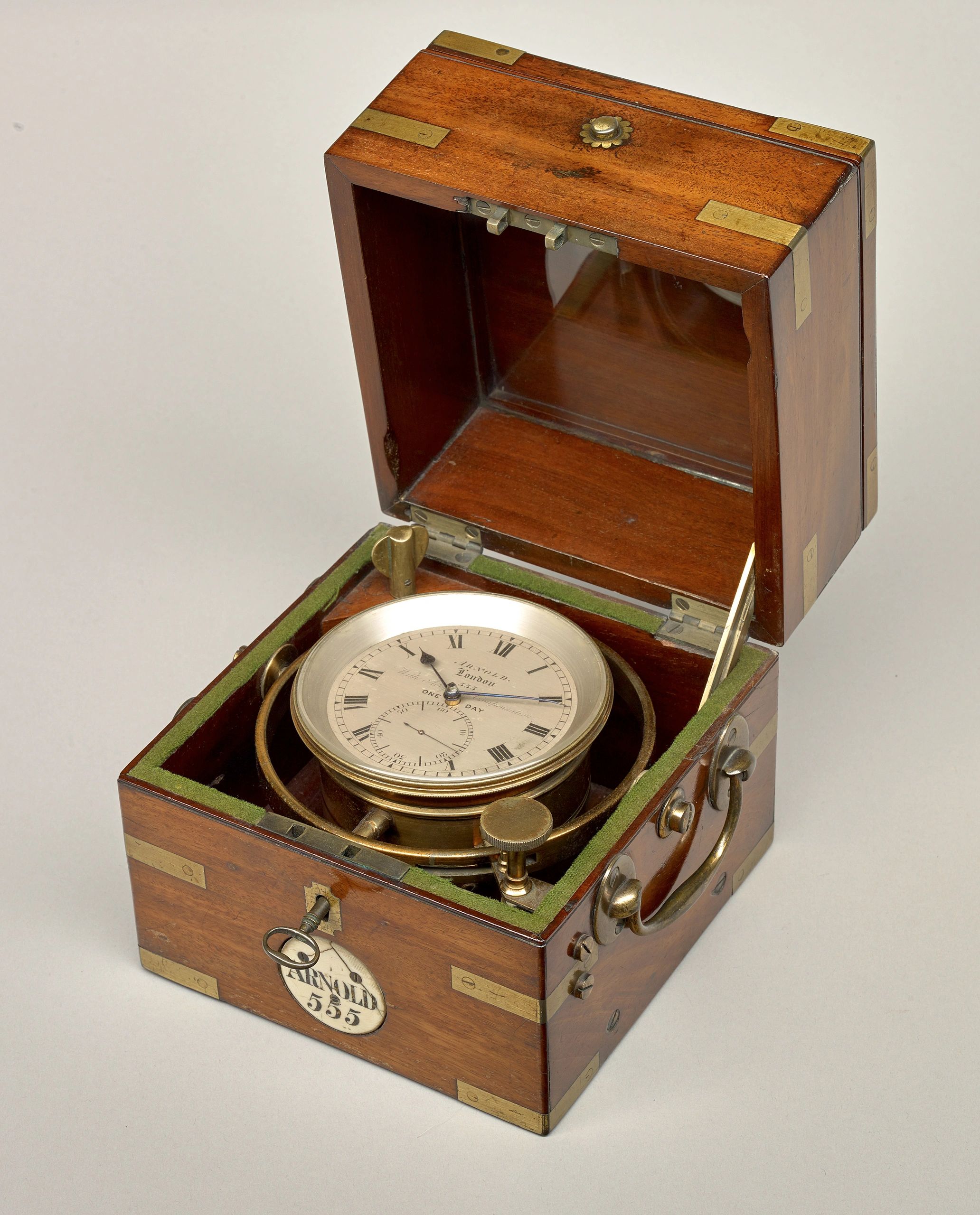 Antique marine chronometer in wooden box.