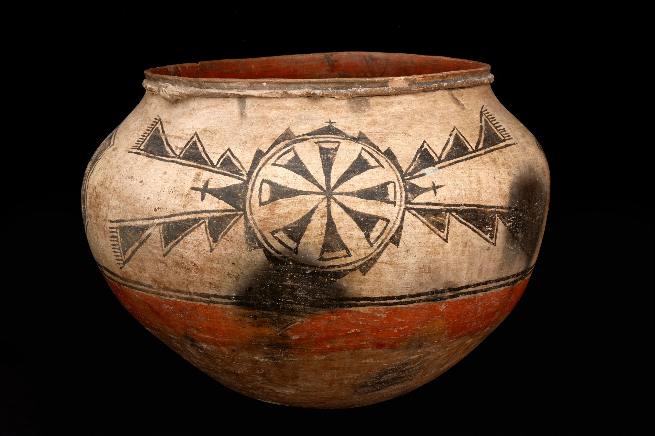Ancient pottery with geometric designs and arrows.