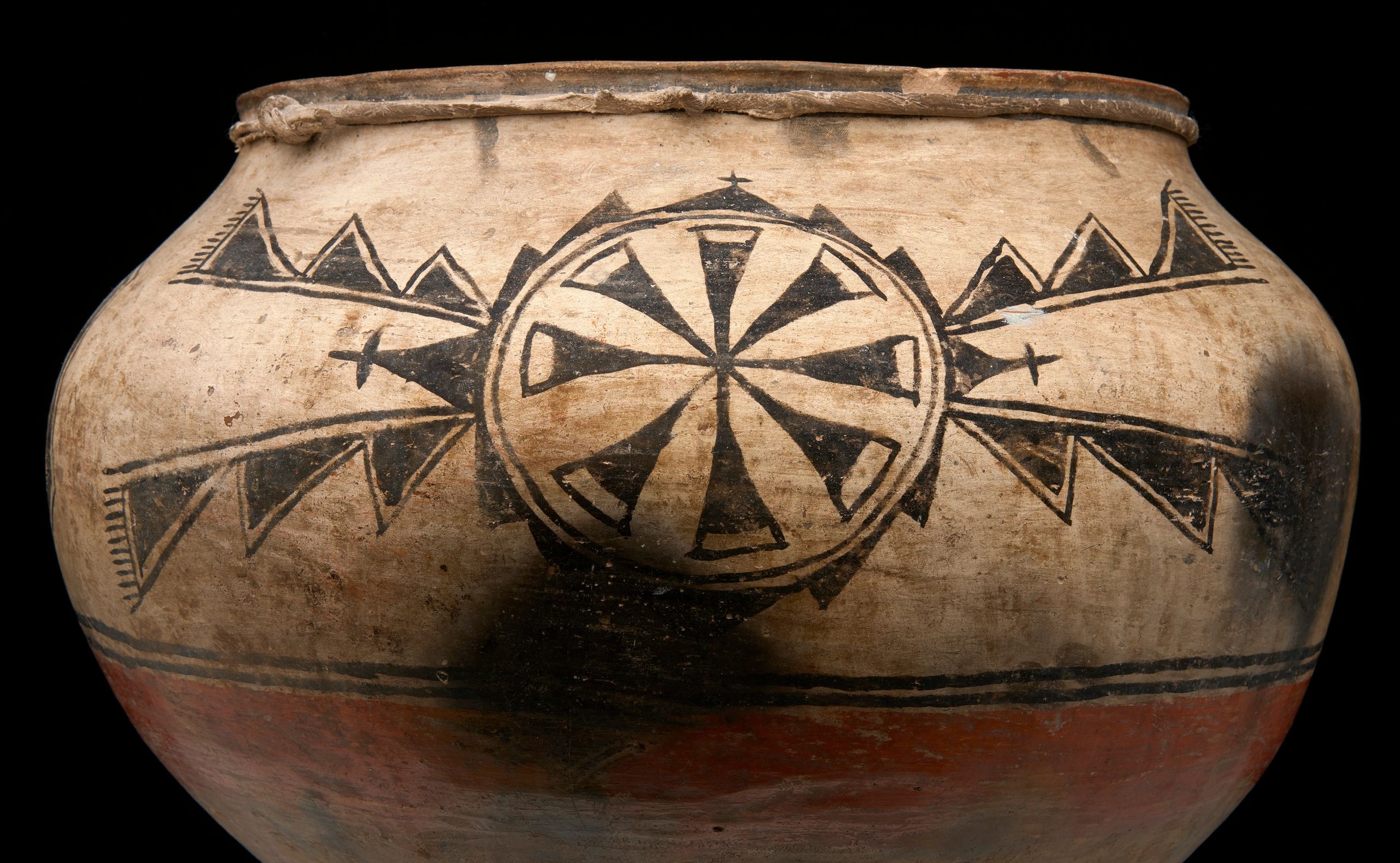Ancient pottery with geometric patterns and symbols.
