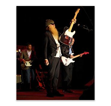 Musicians performing on stage with guitars.