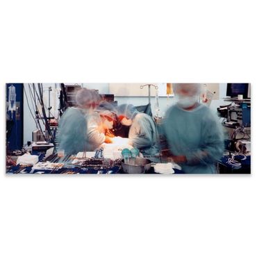 Blurry image of surgeons performing an operation in an operating room.