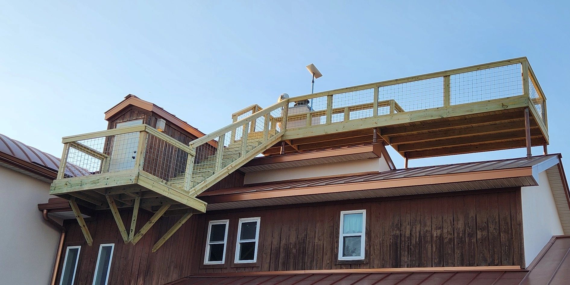 Custom elevated wood deck with railings built for a Central Texas home.
