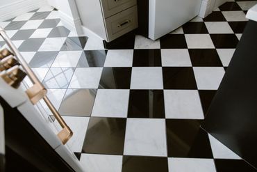 Black and white checkered tile floor in a kitchen area.