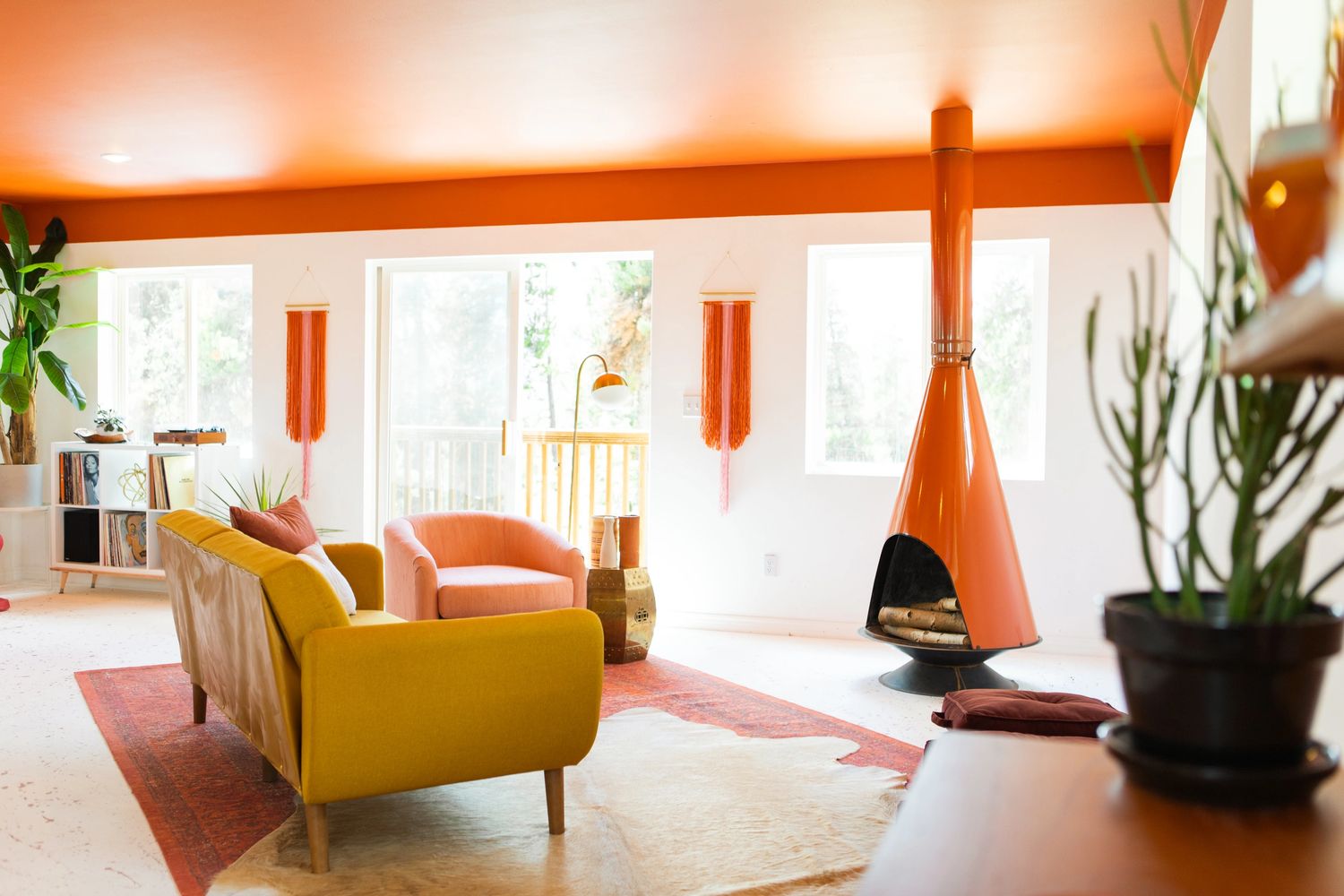 Mid century modern living room with orange fireplace designed by Jasmine Bible Design.