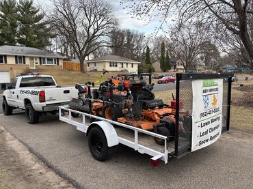 Picture of our lawn mowing truck and trailer.