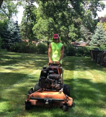 One of our trusted employees mowing a customers yard.
