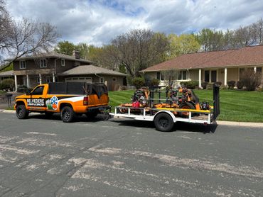 Work truck parked in front of a customer's house after mowing the lawn