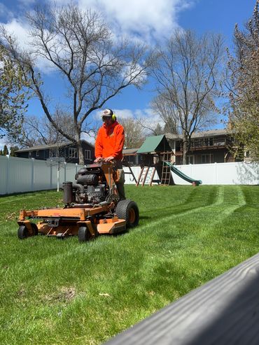 One of our guys mowing a customer's lawn