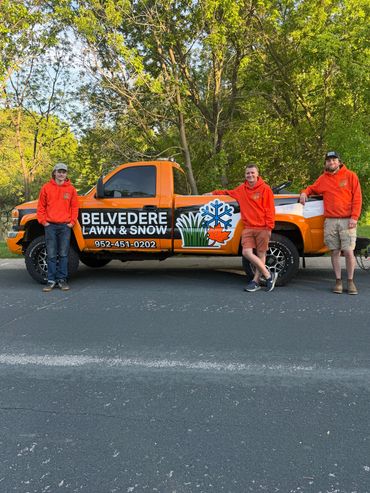 Group of employees standing in front of the work truck