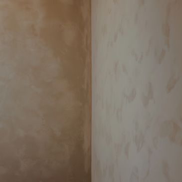 Two adjacent walls with different textured paint finishes in beige tones.
