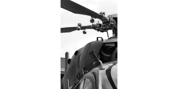 Automated machinery cutting metal with sparks flying.