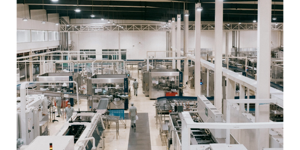 High-speed production line with cans on conveyor belts.
