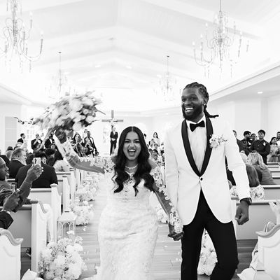 Happy couple walking down the aisle after wedding ceremony.
