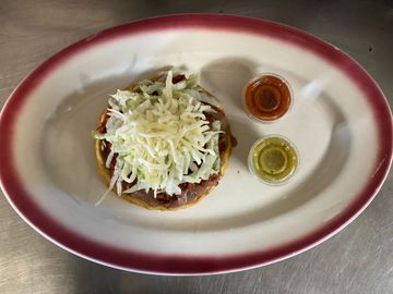 Top view of some dish with chutney in a plate