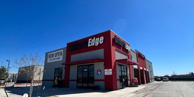 Exterior view of a black and red building under a clear blue sky.