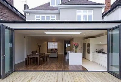 Modern open-plan kitchen and dining area with glass doors.