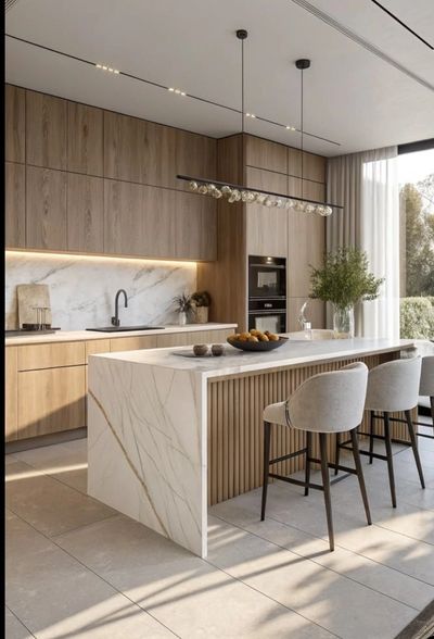 Modern kitchen with marble island and wooden cabinetry.