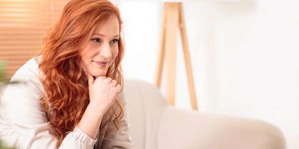 a cheerful, older female therapist sits across from a younger female client