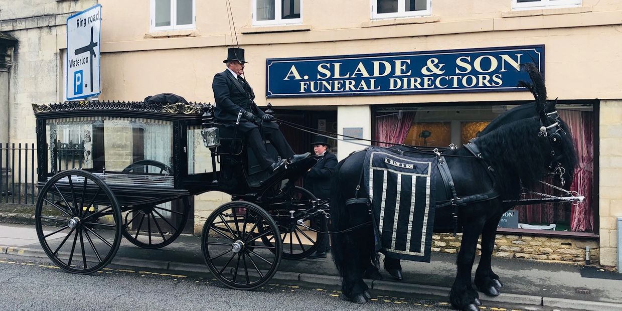 Horse Drawn Hearse  in Cirencester  out side A Slade and Son Funeral Directors