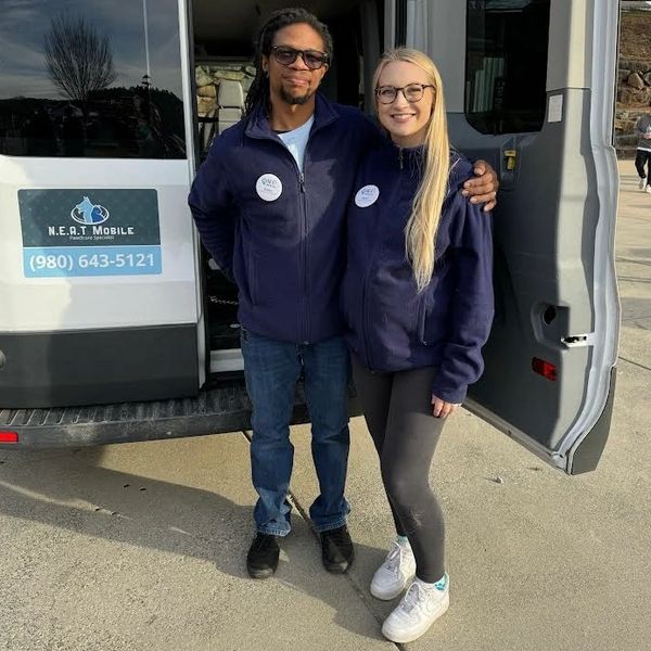 Walter and Sarah standing behind van