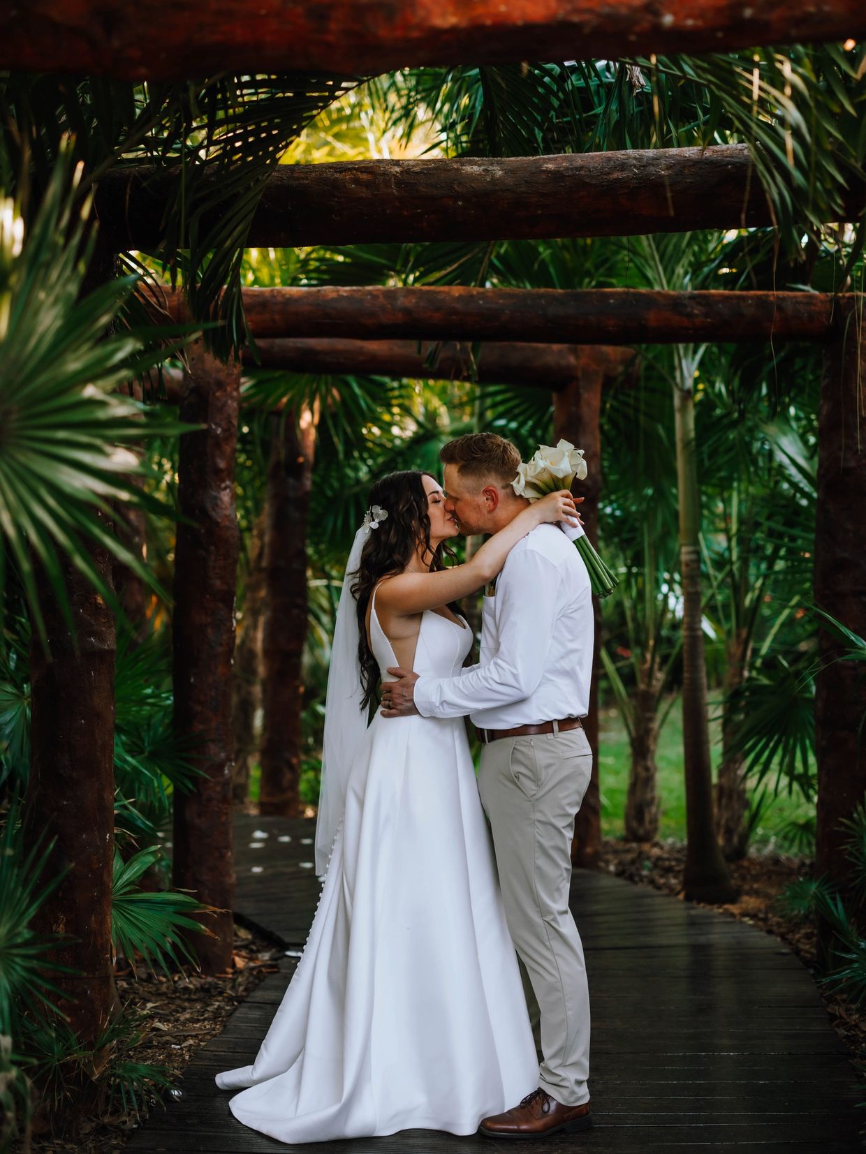 Destination wedding in Mexico. Bride and groom kissing in tropical forest!