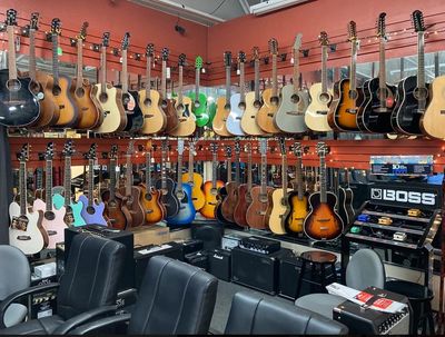 Showroom photo of guitars, amplifiers and Boss pedals.