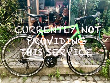 A colorful road bike in a garden courtyard.