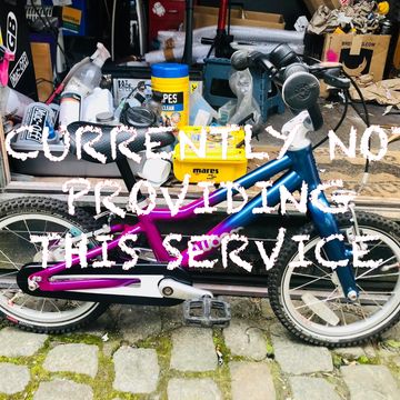 A colorful bike in front of a cluttered workshop with text overlay.