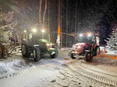 Professional Snow Removal Services in Chelsea Quebec. Two tractors for snow removal in the snow.