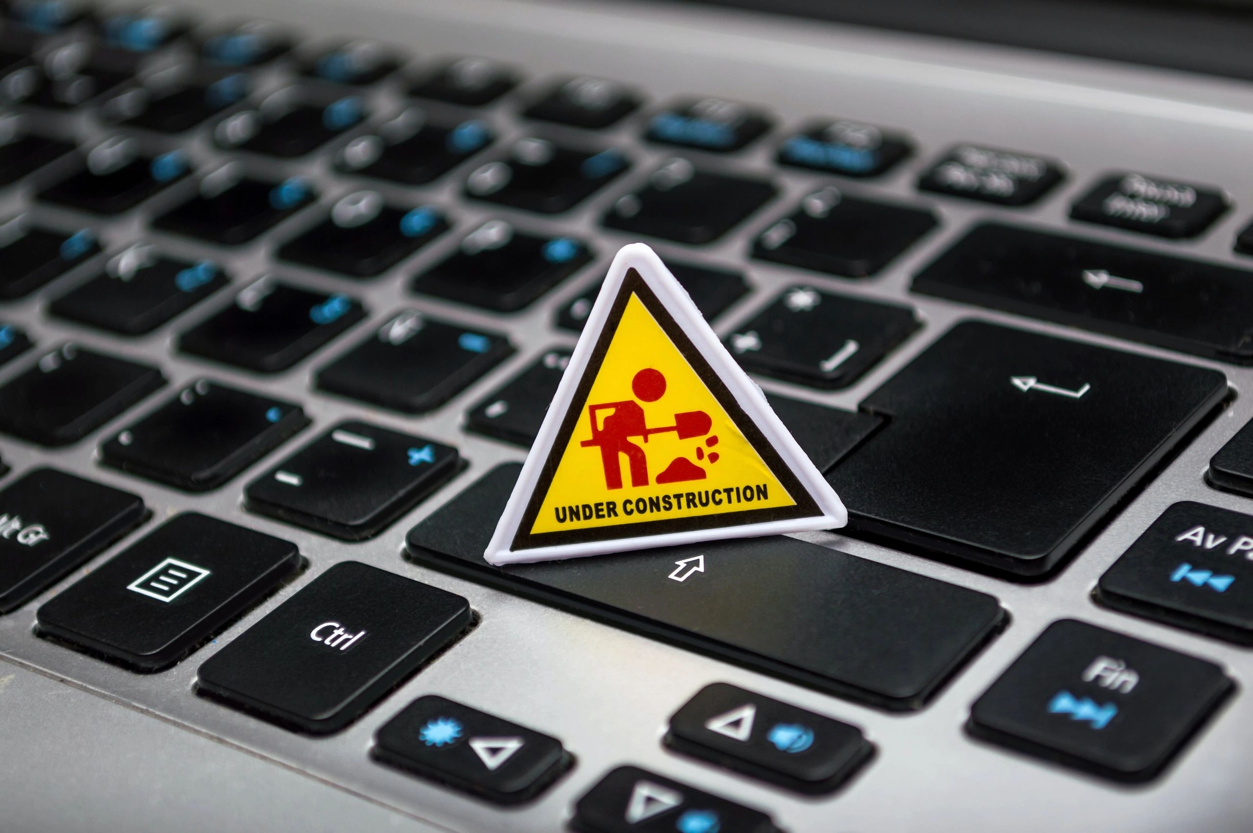 Under construction sign on a laptop keyboard.