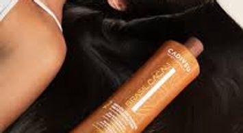 Bottle of Cadiveu Brazil Cacau Hair Treatment on black fabric.